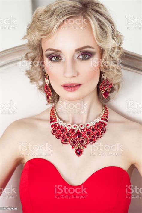 Portrait Of Young Adult Blonde Model With Wavy Hair Decorating Red