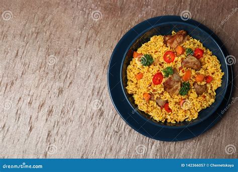 Plate Of Rice Pilaf And Meat On Wooden Background Top View Stock Image