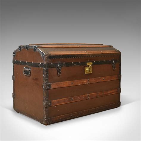 An Old Wooden Trunk Is Shown On A Gray Background With The Lid Open And