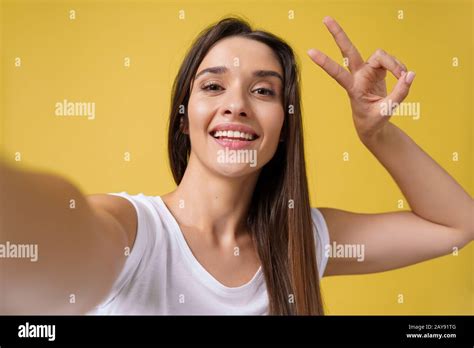 Portrait Of Laughing Young Woman Taking Selfie With Smartphone Hi Res