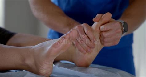 Manual Therapist Is Massaging Feet Of Female Patient In Osteopathic Clinic Curing Of Diseases