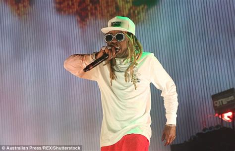 White guy with dreads, smiling in a photo surrounded by young african children. US rappers Lil Wayne and Tyga perform at Sydney festival | Daily Mail Online