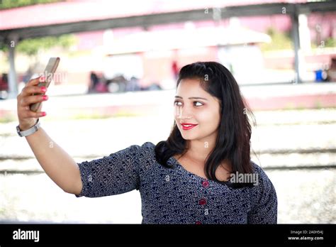 Gorgeous Indian Girl Taking Selfie By Using Mobile Phone At Railway