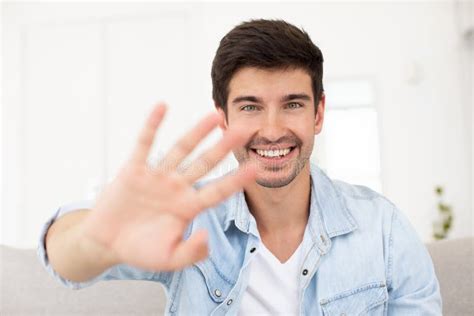 Portrait Happy Smiling Young Man Waving Hand Looking At Camera