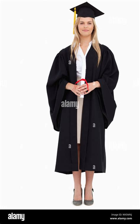 Blonde Student In Graduate Robe Against White Background Stock Photo