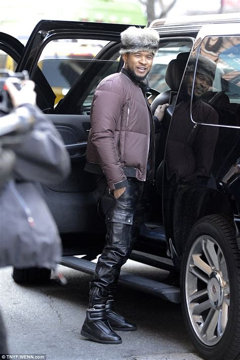 Usher Dons Coonskin Cap And Camouflage Trousers As He Steps Out For