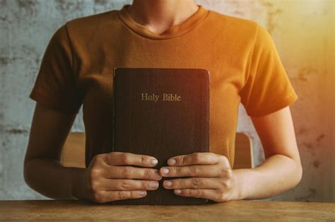 Premium Photo Woman With Bible Praying Hands Clasped Together On Her