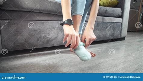 Woman Putting Socks While Sitting In Couch Stock Image Image Of