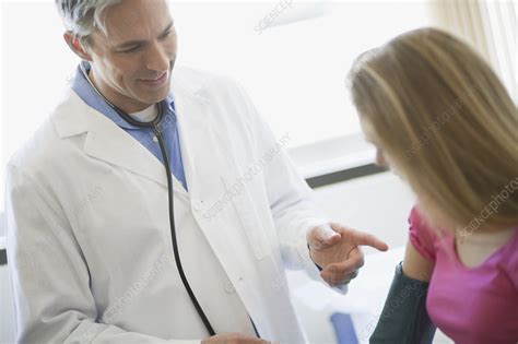 male doctor examining girl patient stock image f003 7588 science photo library