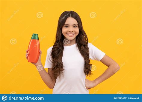 Smiling Teen Girl With Long Hair Hold Shampoo Bottle Promotion Stock