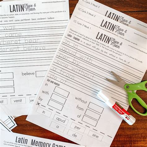 two worksheets and some scissors on a wooden table with paper that says latin memory games