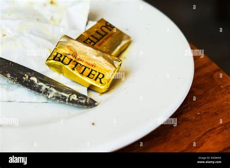 Small Packets Of Butter On A Plate Stock Photo Alamy
