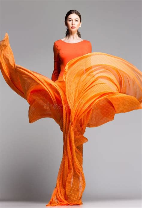 Beautiful Woman In Long Orange Dress Posing Dramatic Stock Image Image Of Body Model