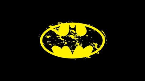 The Batman Symbol Is Shown In Yellow On A Black Background With Grungy