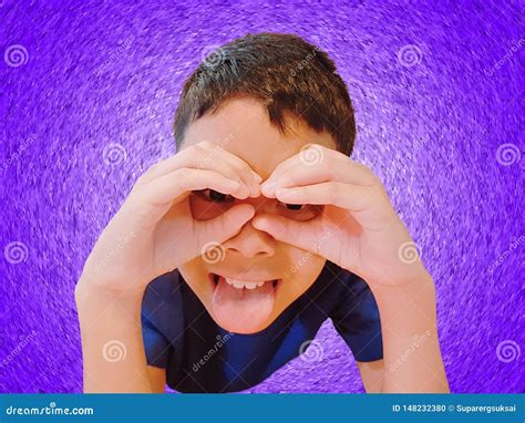Funny Boy Gesturing Hand And Fingers Over Eyes On Violet Background