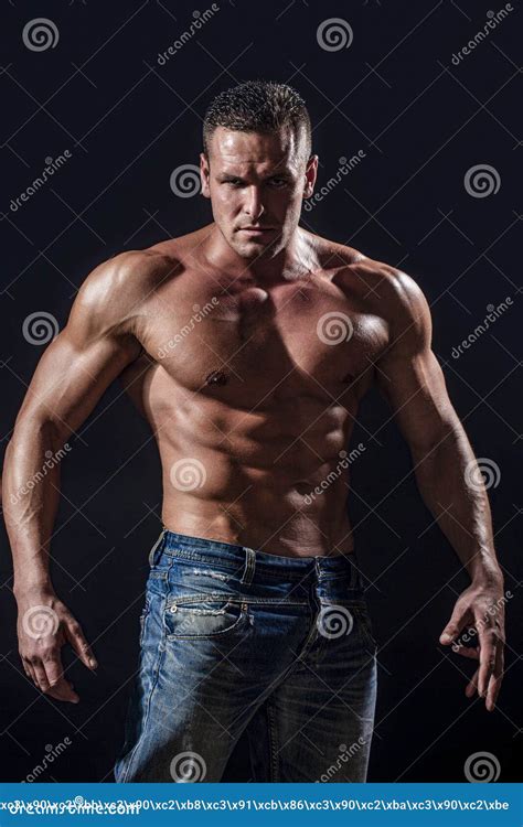 Muscular Topless Man Sitting Topless With Dumbbells In The Gym Royalty