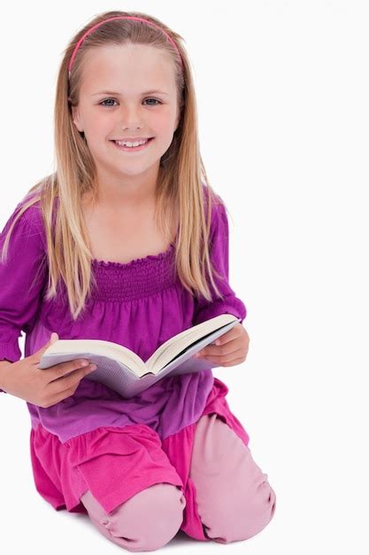 Premium Photo Portrait Of A Smiling Girl Reading A Book