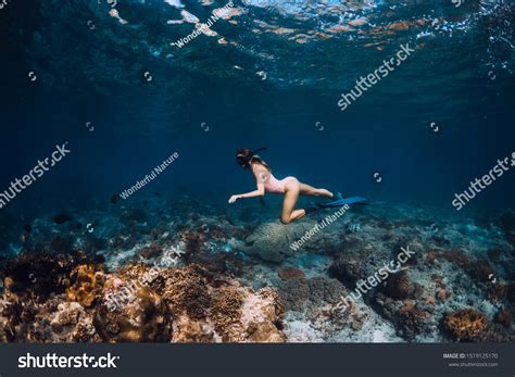 Woman Freediver Glides Over Bottom Underwater Stock Photo