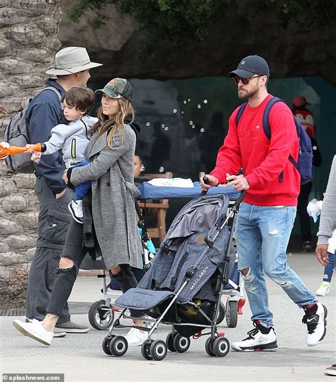 justin timberlake and wife jessica biel coordinate in ripped denim and baseball caps with son