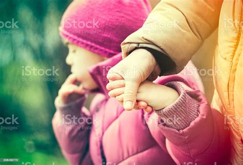 Mother And Daughter Walking And Holding Hands Stock Photo Download