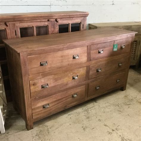 Dresser appears to be a pressed wood in dark cherry finish with brass batwing pulls. Six Drawer Dresser - Nadeau Miami