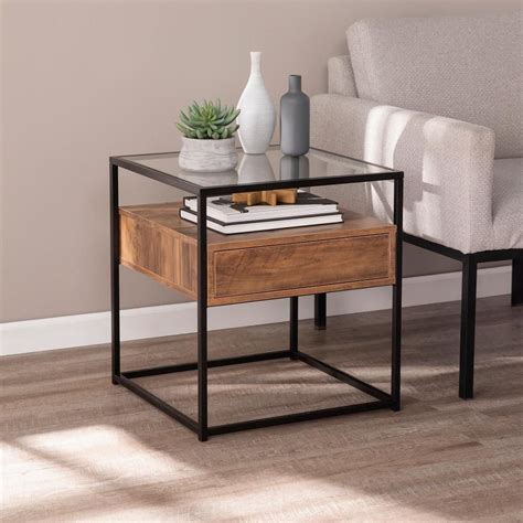 Set this lovely end table in your living room for the perfect place to rest a cup of tea and movie night snacks. Southern Enterprises Winnifred Black and Natural Glass-Top ...