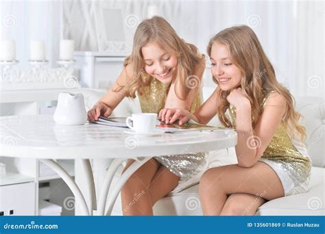 Cute Twin Sisters Sitting At Kitchen Table Stock Image Image Of Preteen Girls 135601869