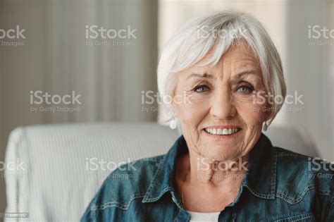 Smiling Senior Woman Relaxing At Home In The Afternoon Stock Photo