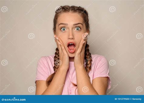 Portrait Of Shocked Young Woman On Light Background Stock Image Image