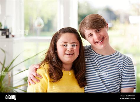 Portrait Of Loving Young Downs Syndrome Couple At Home Together Stock
