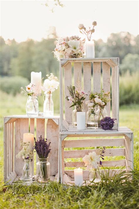 A rustic floral decoration with yellow and purple blooms and pebbles. Inspiring Summer Wedding Décor - PRETEND Magazine