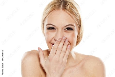 Happy Young Woman Laughing With A Hand Over Her Mouth Stock Photo