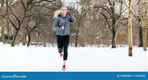 Woman Running Down A Path On Winter Day In Park Stock Image Image Of