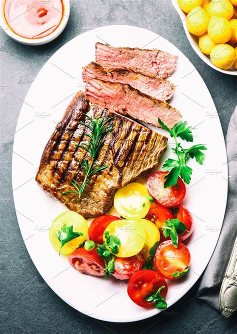 Sliced Medium Rare Grilled Beef Steak Served On White Plate With Beef