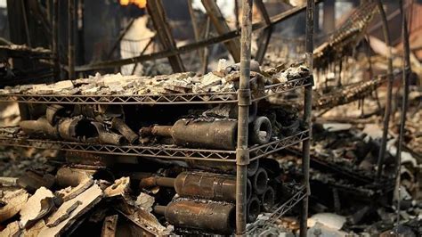 Burned Out Wine Bottles Sit On A Rack At The Fire Damaged Signarello