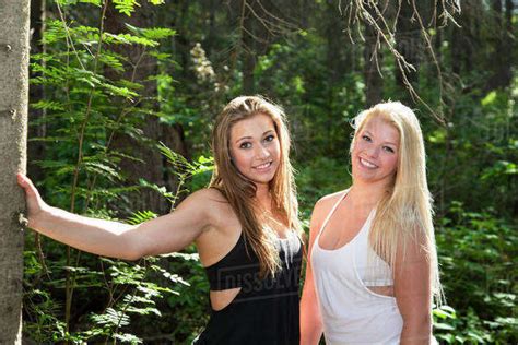 Two Girlfriends Posing Together In The Woods In The Sunshine Edmonton Alberta Canada Stock