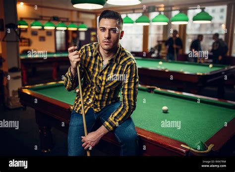 Male Billiard Player With Cue Poses At The Table Stock Photo Alamy