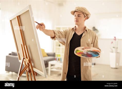 Teenage Painter Painting On A Canvas In An Art Studio Stock Photo Alamy