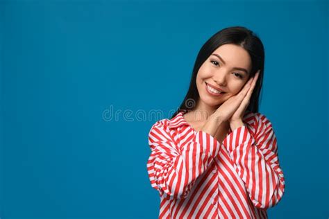 Beautiful Asian Woman Wearing Pajamas On Blue Space For Text Bedtime