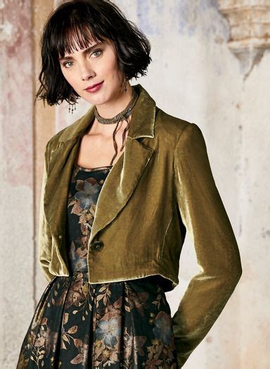 A Woman Wearing A Green Jacket And Floral Dress
