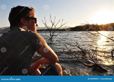 Young Man Sitting Quietly Beside Lake Stock Photo Image Of Lonely