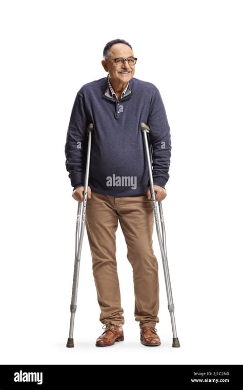 Cheerful Mature Man Standing With Crutches Isolated On White Background
