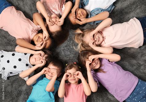 Little Children Lying On Carpet Together Indoors Top View