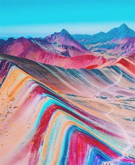 An Aerial View Of Colorful Mountains And Valleys