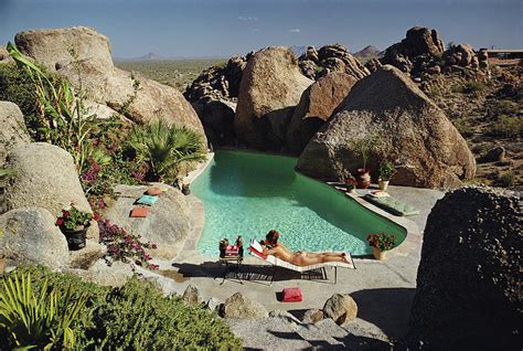 Les Playboys Slim Aarons A Woman Sunbathing Nude By Tom Darlingtons Pool In Carefree