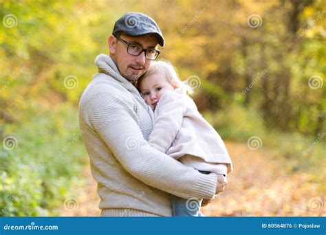 Father Holding Little Daughter In His Arms Autumn Nature Stock Photo