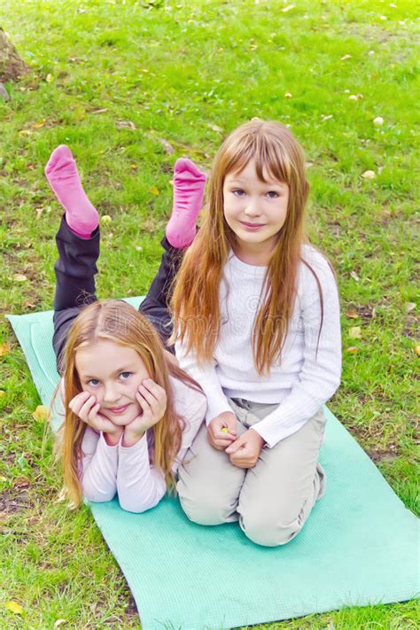Two Girls Sitting On Grass Stock Image Image Of Outdoors 56158553