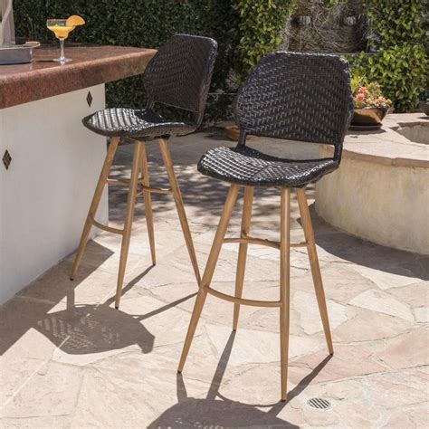 Noble House Bianca Faux Rattan Outdoor Bar Stool With Brown Wood Finish