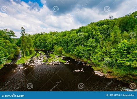 Mountain River Flowing Along Green Hills Lush Vegetation Landscape