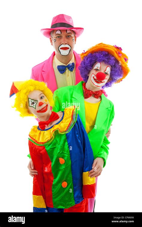 Three People Dressed Up As Colorful Funny Clowns Over White Background